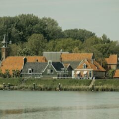 a row of houses next to a body of water
